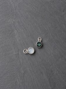 Fused glass memorial charms prepared for setting into bespoke silver jewellery.