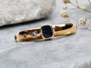 Gold ring with rectangular blue sapphire and flush-set diamonds handmade by Cornovii Silver in Cornwall.