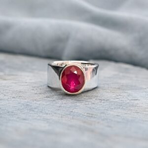 Wide silver ring with oval ruby gemstone, redesigned and handmade by Cornovii Silver in Cornwall.