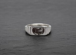 Silver signet ring engraved with a dog nose print recreated from a photograph.
