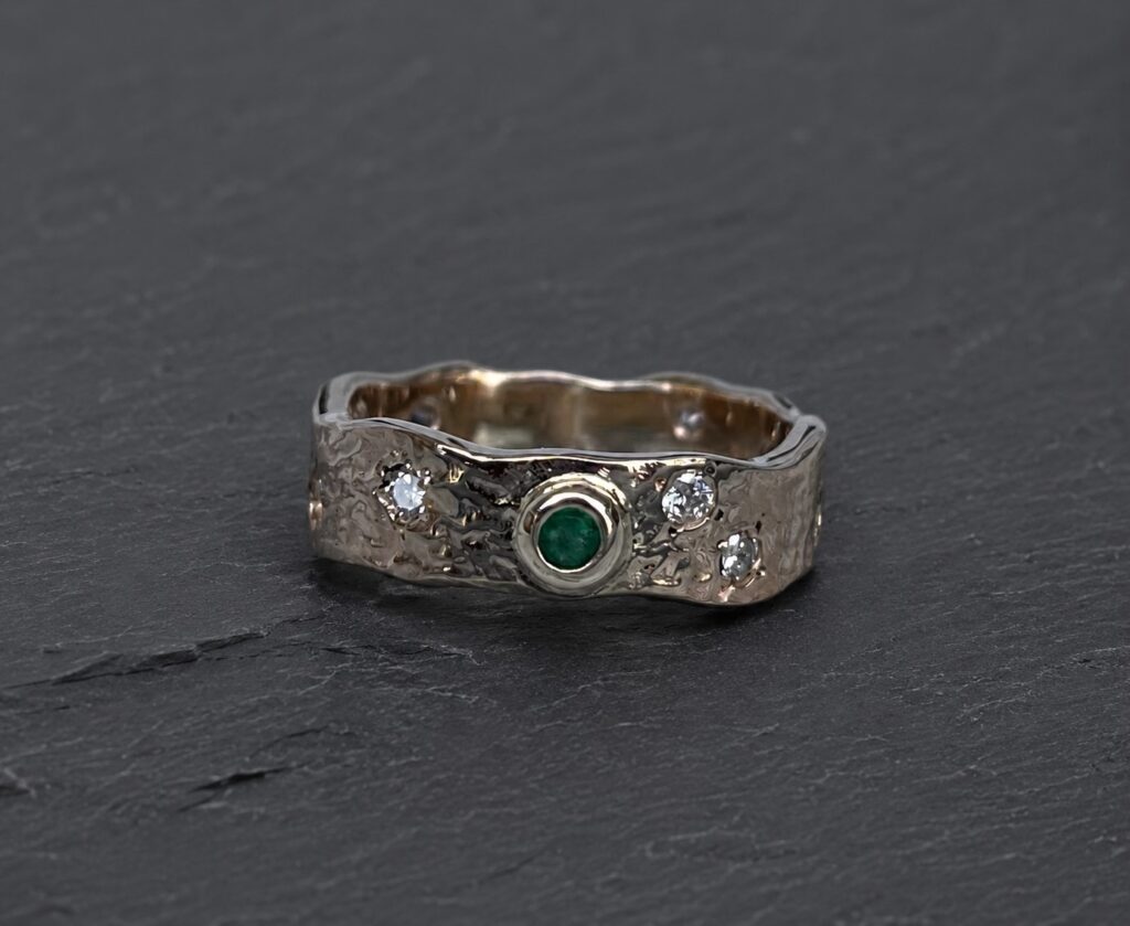 gemstone-ring-repair Gold ring set with gemstones - emerald and diamond.