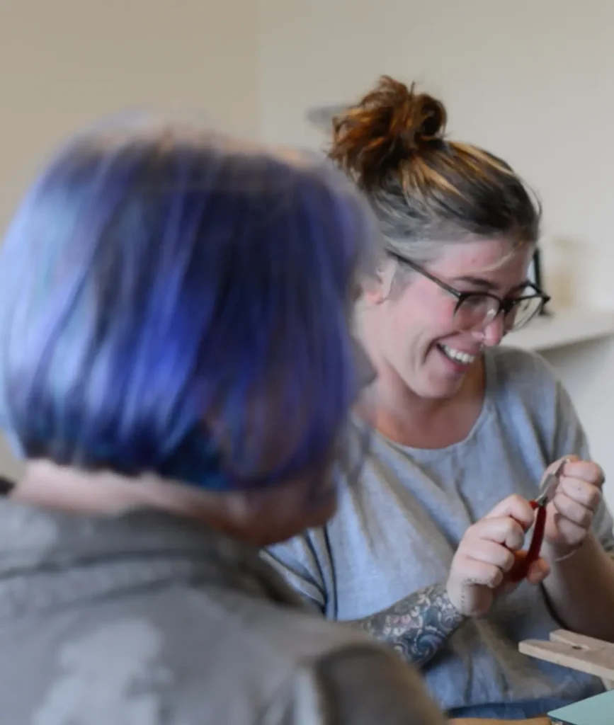 Jo helping a student make a silver chain during a silversmithing course in Cornwall