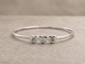 Silver memorial bangle set with three family birthstones.