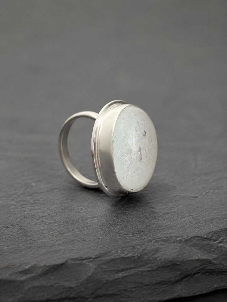 white-sparkly-ashes-in-glass-ring-side White ashes-in-glass memorial ring showing cremation ashes permanently fused within the glass.